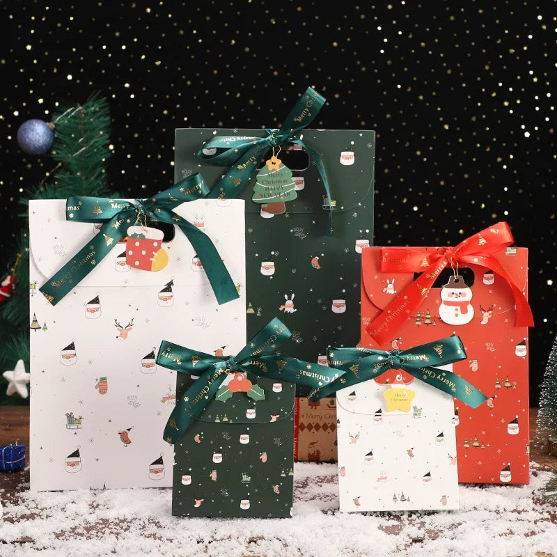 Red, green and white Christmas paper gift bags with ribbon bows