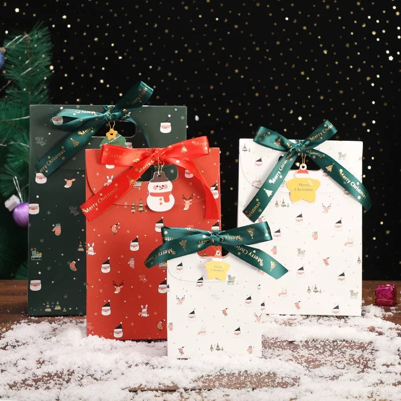 Red and white Christmas paper gift bags with green ribbons