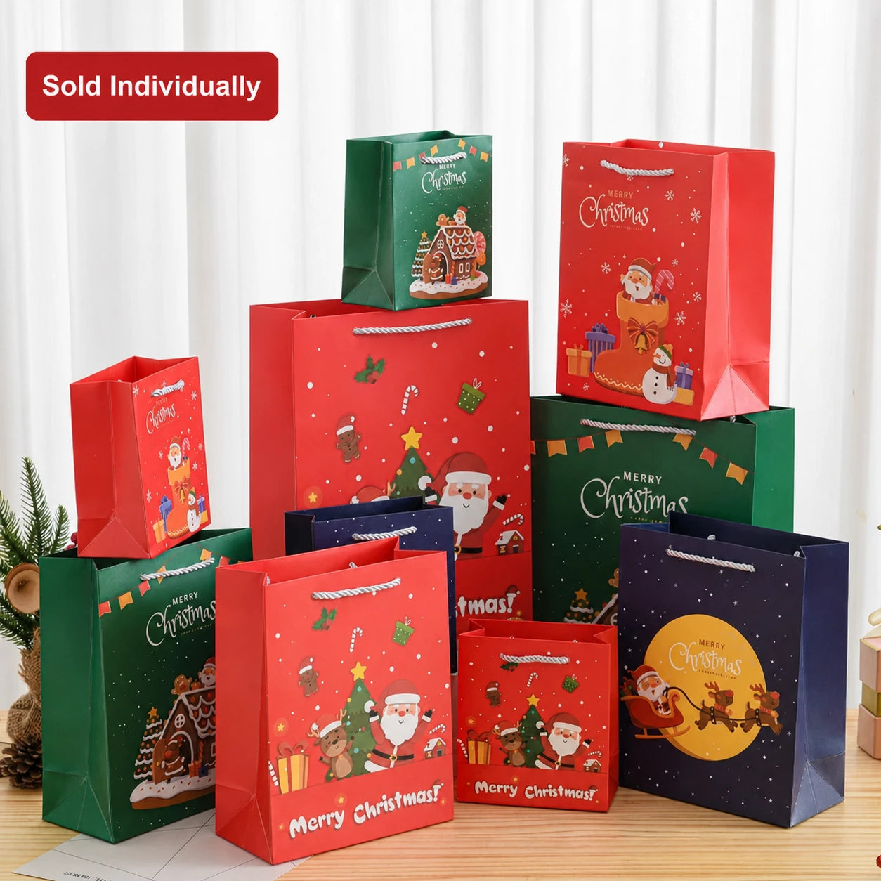 Tall white cardstock Christmas gift bags with rope handles in ready-stock holiday designs