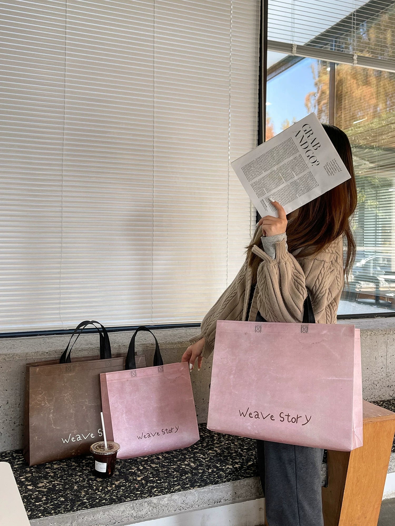 Model carrying vintage laminated non-woven tote bags