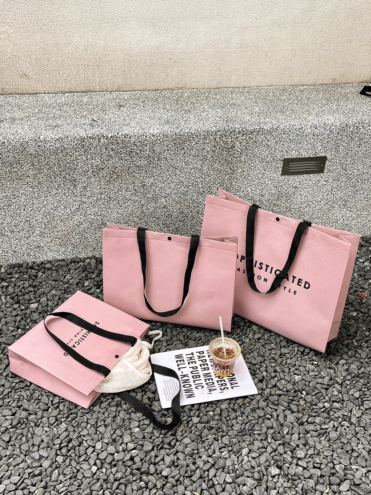 Pink woven-handle non-woven tote bags in three sizes