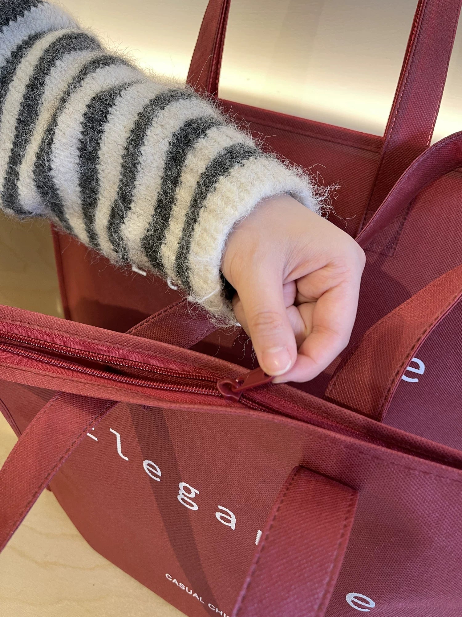 Close-up of secure zipper closure on a non-woven tote bag